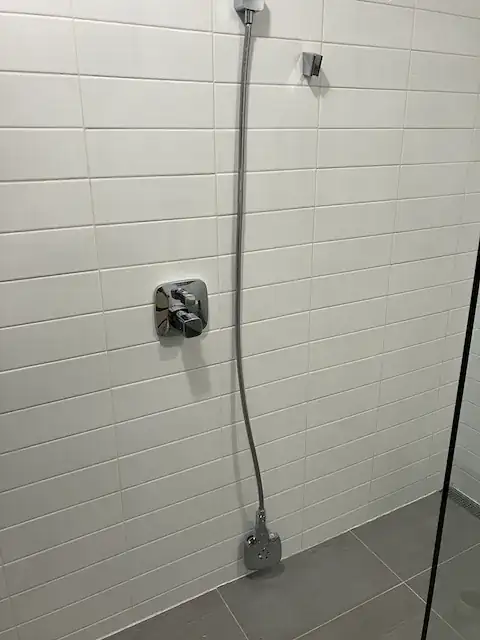 Showing reinstalled handshower now not touching the floor.