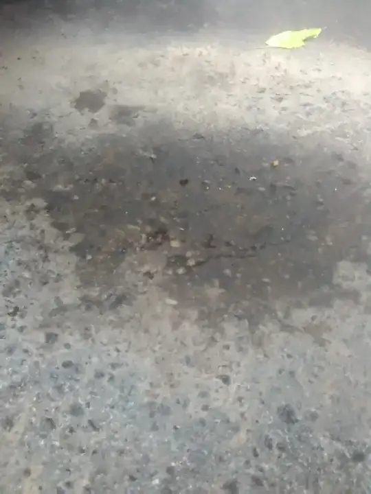 cracked and pitted asphalt due to contamination with ATF