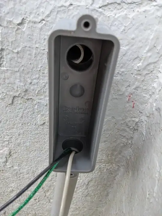 rear of toilet near the wall