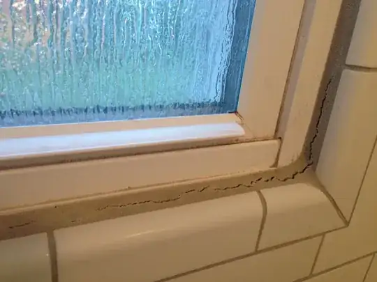 The cracked grout around my window in my shower