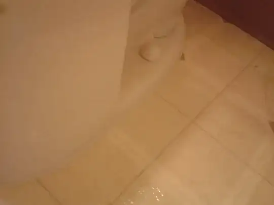 toilet which sits flat on the floor, grouted with sanded cement grout