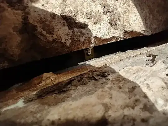 tape measure shown protruding into gap as seen from exterior side of wall