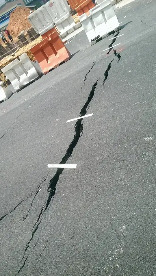 masking tape over road crack during road work