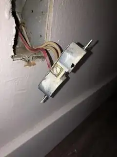 outlet with 2 white wires attached to 1 screw on right of outlet with 1 red wire attached to 1 screw on left of outlet