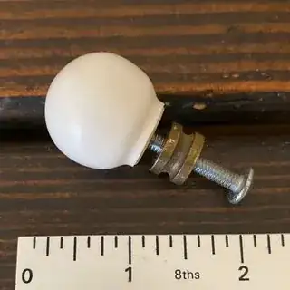 Porcelain pull with screw and spacer attached.