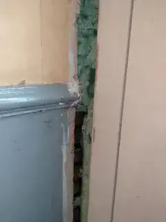 Large gap between front door frame and wall.