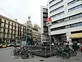 Entry point to Barcelona Plaça Catalunya Station from the street in Plaça Catalunya. Blue logo sign points FGC trains