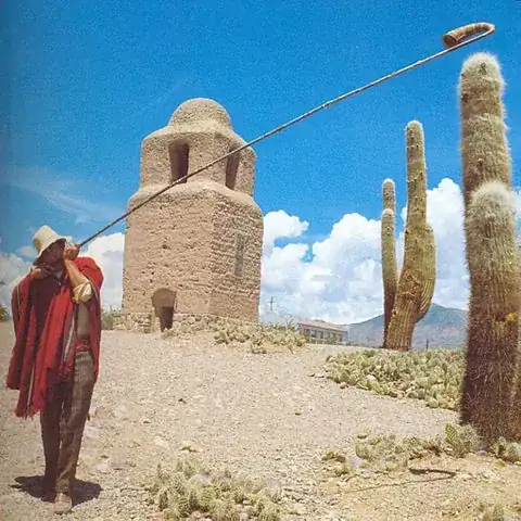 Man playing an Erka in a desert setting