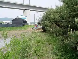 Tractor passing under the KTX line in Yacheon-ri, Hwaseong37°14′49″N 126°55′17″E / 37.24694°N 126.92139°E / 37.24694; 126.92139