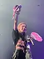 Miyeon holding fan gifts and banners during encore.