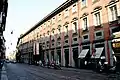 A view of the Via Manzoni, showing the Museo Poldi Pezzoli surrounded by several shops, such as the Caffe dell' Opera.