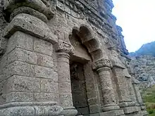 The main temple features a Kashmiri-style cusped archway
