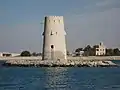 Al-Maqta' Tower (Arabic: بُرْج ٱلْمَقْطَع, romanized:&nbsp;Burj Al-Maqṭaʿ; front) and Al-Maqta' Fort (Arabic: حُصْن ٱلْمَقْطَع, romanized:&nbsp;Ḥuṣn Al-Maqṭaʿ; back), just outside the island of Abu Dhabi