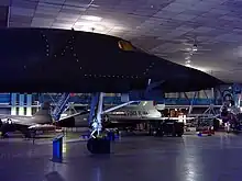 The nose section of a B-1A on display with outline of the ejection capsule denoted