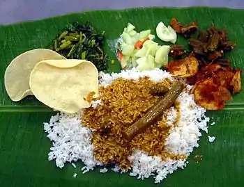 Image 91A typical serving of banana leaf rice. (from Malaysian cuisine)