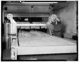 machinery with glassware on it and conveyer to oven
