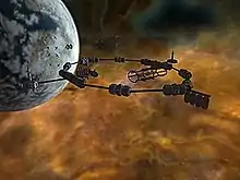 A brown murky cloud is set against a black void. In front of the cloud at the top left is a grey sphere, pockmarked with craters. A metal structure, consisting of cylinders interconnected in the shape of a ring, floats in the foreground.
