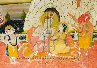 Shiva and Paravti sitting down next to each other.