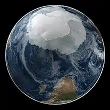 Image 31A composite image of Earth, with its different types of surface discernible: Earth's surface dominating Ocean (blue), Africa with lush (green) to dry (brown) land and Earth's polar ice in the form of Antarctic sea ice (grey) covering the Antarctic or Southern Ocean and the Antarctic ice sheet (white) covering Antarctica. (from Earth)