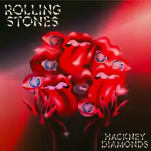 A mass of eyeballs with diamonds in them and lips with tongues sticking out held up by red hands