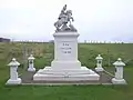 War memorial, including a statue of Saint George, outside the chapel