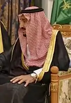 Image 12Red and white keffiyeh commonly worn in the desert held with a black agal (from Culture of Saudi Arabia)