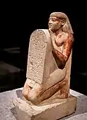 Kneeling portrait statue of Amenemhat holding a stele with an inscription; c. 1500 BC; limestone; Egyptian Museum of Berlin (Germany)