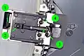 The deployable petal is grabbed by the Capture Latch at the tip of the Roller Link (1). If necessary, the link can be released during EVA by loosening a bolt (2). “Locking out” the spring-loaded actuator with a bolt (3) allows the astronaut to “safe” the mechanism before manual operation. The petal structure can be separated from the deployment mechanism with two bolts (4).