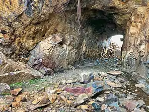 2018 photograph of Needle's Eye Tunnel, near the summit of Rollins Pass. This view shows the northeast portal in the foreground; the southwest portal can be seen in the background. Wire mesh and metal dowels were installed in August 1987 to help reduce additional rock falls and preserve the condition of the tunnel constructed in 1903 (120&nbsp;years ago)&nbsp;(1903).