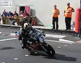 Michael Dunlop (3) Suzuki&nbsp;— Formula 1 Classic TT 2013 - Lap 3&nbsp;Parliament Square, Ramsey 26 August 2013