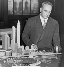 Image 28Robert Moses with a model of his proposed Battery Bridge, never built (from History of New York City (1898–1945))