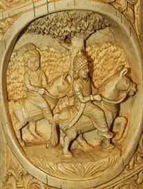 Two figures wearing headdresses, riding horses