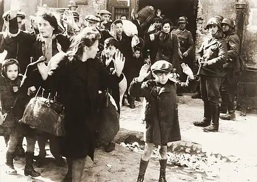 Image 12Warsaw Ghetto UprisingPhoto credit: USHMMJews captured by SS and SD troops during the suppression of the Warsaw Ghetto Uprising are forced to leave their shelter and march to the Umschlagplatz for deportation. The SD trooper pictured second from the right, is Josef Blösche, who was identified by Polish authorities using this photograph. Blösche was tried for war crimes in Erfurt, East Germany in 1969, sentenced to death and executed in July of that year.More featured pictures