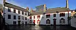 Low yard, adjacent to the main complex: part of the former School (left, rebuilt 1753) and more almshouses (1782).