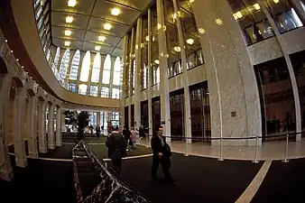 Wide angle view of the mirror and marble-clad elevator core inside the South Tower lobby. The ceiling height is 22&nbsp;m (72&nbsp;ft).