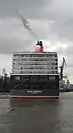 Moving forward very slowly (against the tide), the ship approaches the dry dock.