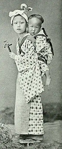 Farmers of forty centuries - Girl carrying and entertaining child.jpg