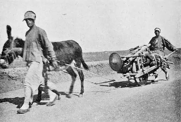 Farmers of forty centuries - vehicles of forty centuries on a modern road of German construction, Kiaochow, Shantung, China.jpg